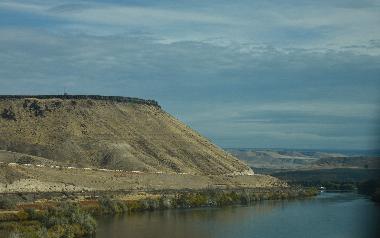 Wide river seen from a bluff under a big sky